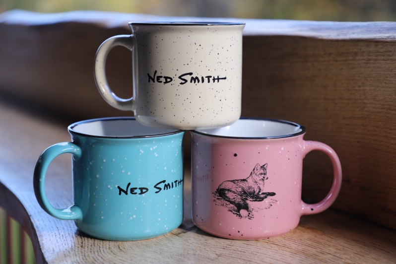 Product Description: A Ned Smith Original Artwork piece of a fox with Ned's printed signature on the opposite side of the mug.</br>Mugs are all 15 oz. and come in Orange, Pink, Green, and Cream. (Blue SOLD OUT)</br> NSC Fox Mug