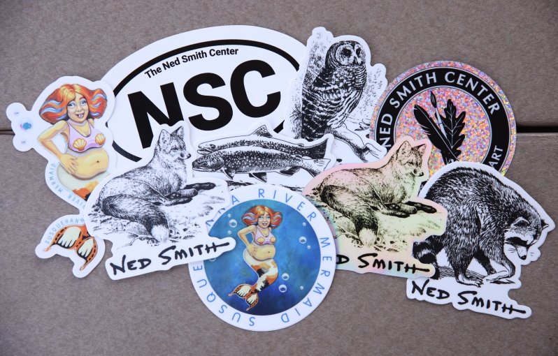 Product Description: 4 Different Black & White Original Ink Drawings by Ned Smith on a vinyl, weatherproof sticker suitable for water bottles, car windows, among other hard surfaces. Stickers measure roughly</br>Choices are (in Inches Width x Height):</br></br>NSC Oval (5"x3")</br>Fox (3"x2.91")</br>Raccoon (2.93"x3")</br>Trout (3"x1.89")</br>Owl (2.32"x3")</br></br>Ned Smith Center Funny Susquehanna River Mermaid Sticker custom art made by local artist Curt Schylaske. Printed on vinyl, weatherproof sticker suitable for water bottles, car windows, among other hard surfaces.</br>Round stickers (3"x3")</br>Die cut stickers (2.5"x4")</br> NSC Stickers & Window Decal